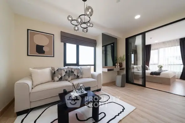 Modern living room with stylish decor and view into cozy bedroom.