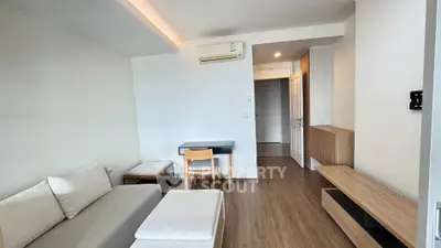 Modern living room with minimalist furniture and wooden flooring