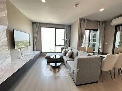 Modern living room with sleek furniture and large windows offering a stunning view.