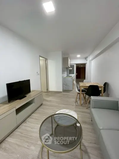 Modern living room with sleek furniture and open kitchen layout