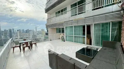 Spacious balcony with stunning city skyline view and modern outdoor seating.
