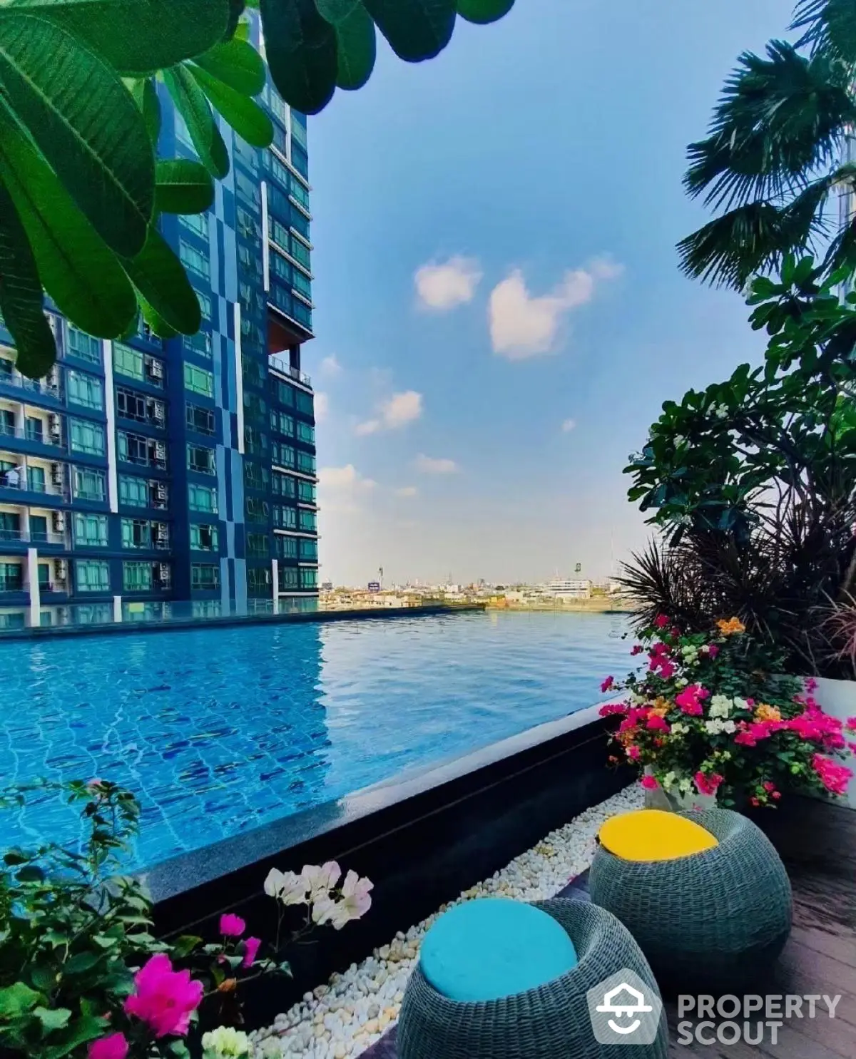 Luxurious rooftop pool with stunning city view and vibrant garden