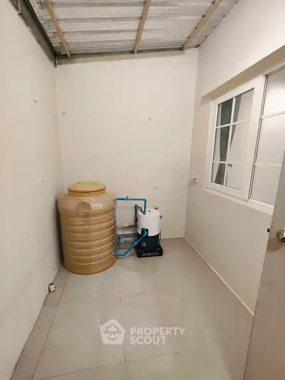 Utility room with water tank and filtration system in modern home