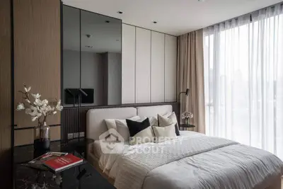 Luxurious modern bedroom with elegant decor and large window offering natural light.