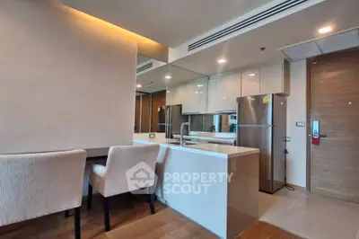 Modern kitchen with sleek design and stainless steel appliances in a stylish apartment.