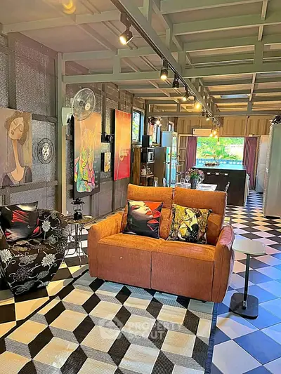 Stylish living room with modern decor and open layout, featuring unique artwork and cozy seating.