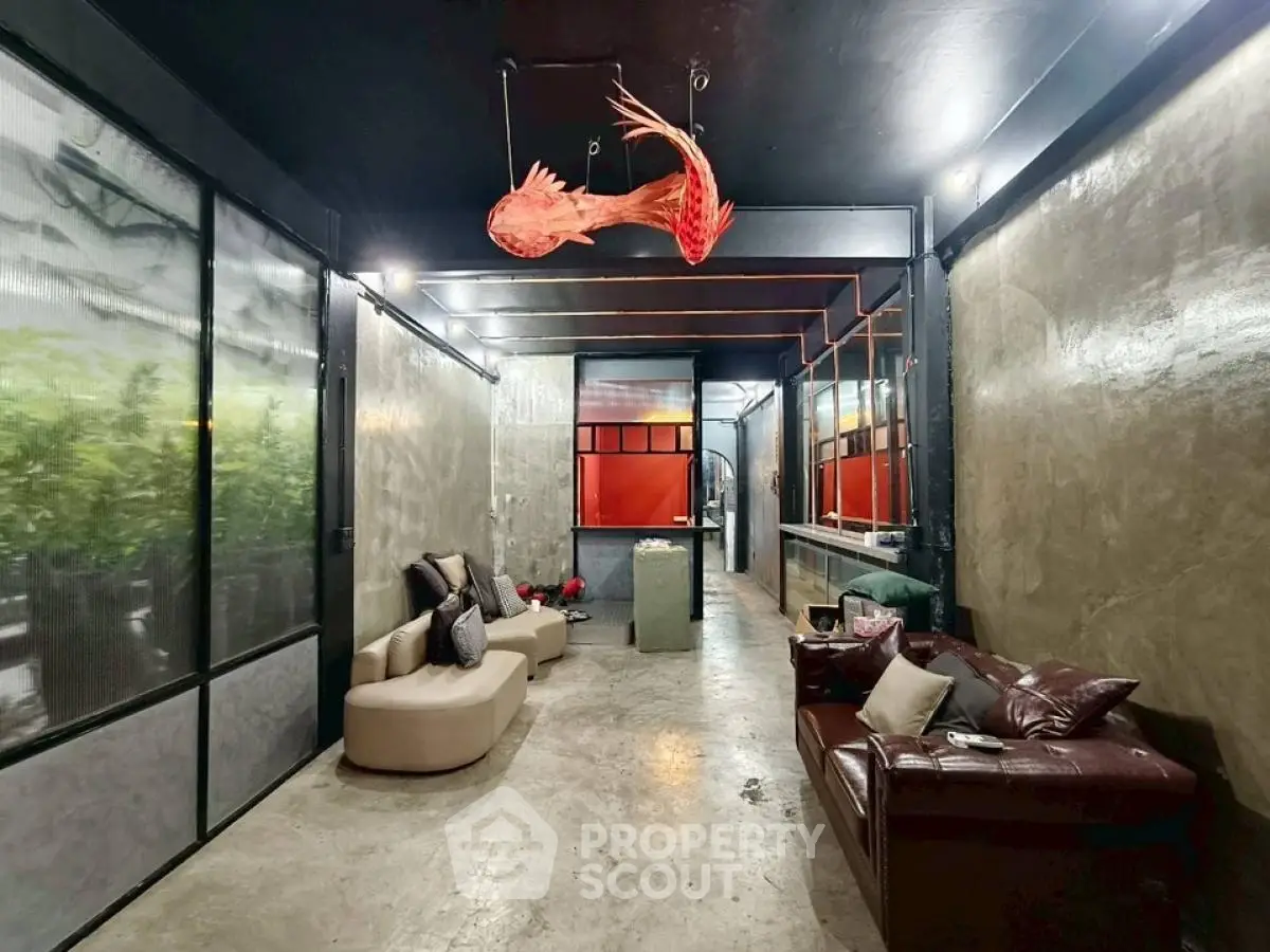 Stylish industrial living room with unique lighting and modern seating