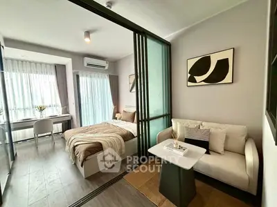 Modern studio apartment with cozy bedroom and stylish living area, featuring floor-to-ceiling windows.