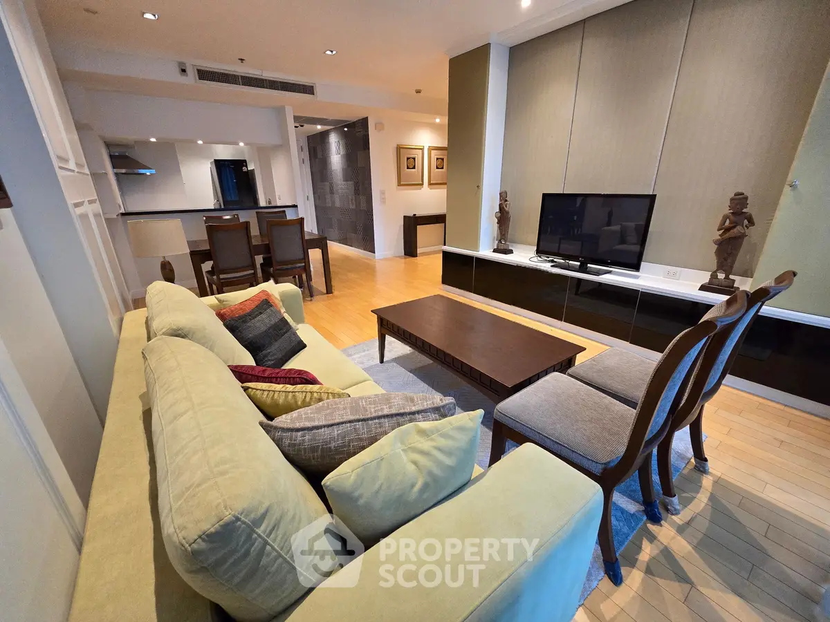 Spacious living room with modern decor and open kitchen layout in luxury apartment
