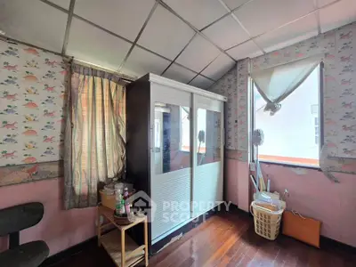 Charming attic room with vintage wallpaper and natural light