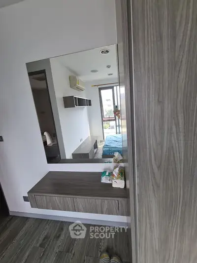Modern bedroom with stylish wood paneling and large window for natural light