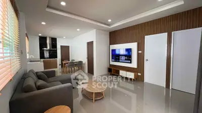 Modern living room with sleek furniture and open kitchen layout