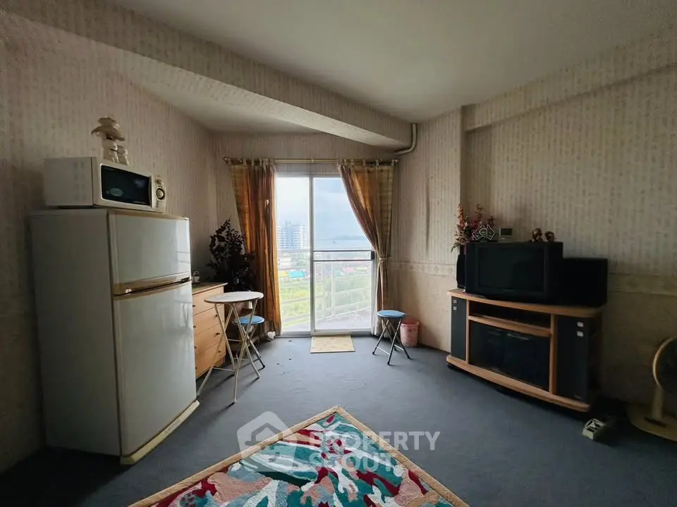 Cozy living room with city view, featuring vintage decor and natural light.