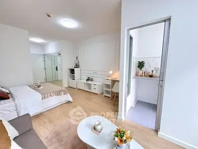 Modern studio apartment with cozy living area and compact kitchen.
