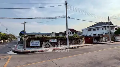 Charming suburban street view with residential homes and clear skies, ideal for peaceful living.