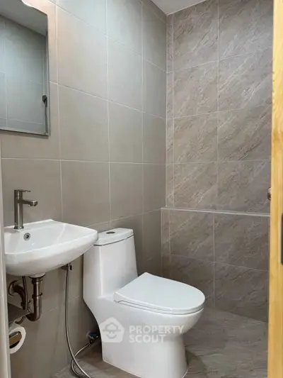 Modern bathroom with sleek fixtures and neutral tile design