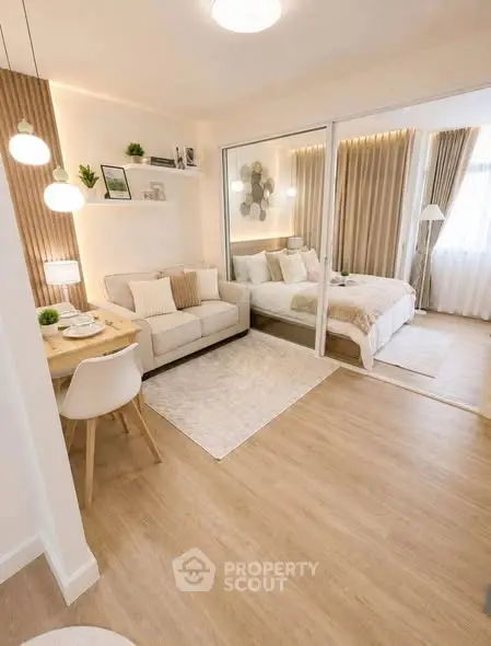 Modern studio apartment with cozy living area and stylish bedroom, featuring elegant decor and natural light.