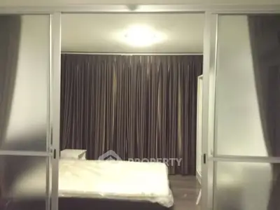 Modern bedroom with frosted glass sliding doors and elegant curtains