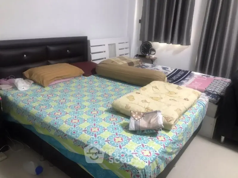 Cozy bedroom with double bed and colorful bedding, perfect for relaxation.
