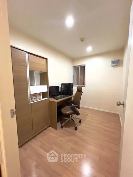Modern study room with sleek wooden flooring and ergonomic office chair.