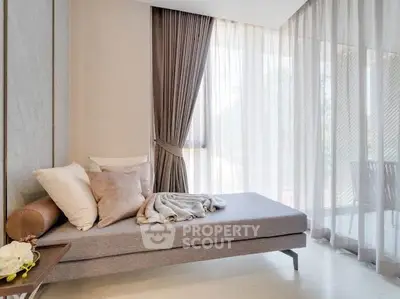 Elegant living room with modern decor and large windows for natural light.