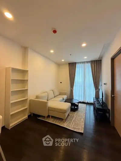 Modern living room with cozy sofa, elegant curtains, and stylish decor in a bright apartment.