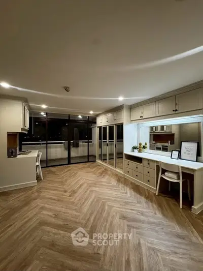 Spacious modern living room with elegant wood flooring and large windows