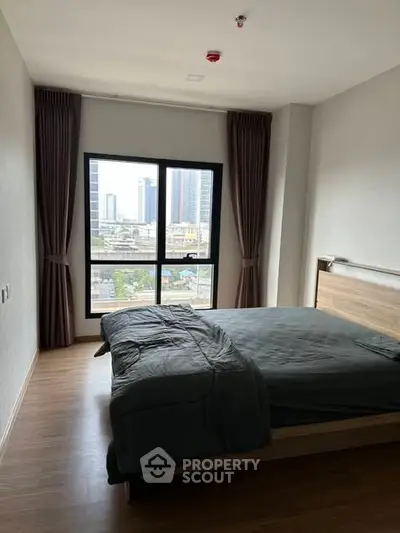 Modern bedroom with city view and stylish decor in urban apartment