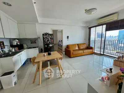 Modern open-plan living room with kitchen and city view balcony