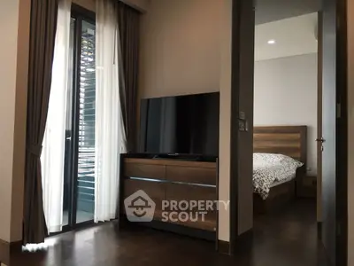 Modern bedroom with wooden furniture and balcony access