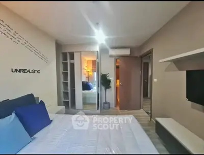 Modern bedroom with stylish decor and ample storage space in a contemporary apartment.