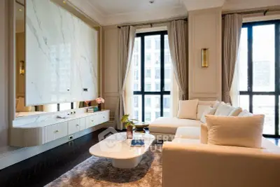 Luxurious living room with elegant decor and large windows offering natural light.