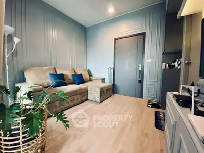 Stylish living room with modern decor and cozy seating in a contemporary apartment.