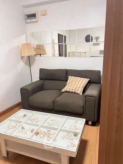 Cozy living room with stylish sofa and decorative coffee table in modern apartment.