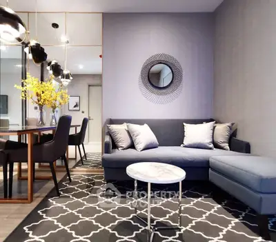 Modern living room with stylish decor, cozy sofa, and elegant dining area in open layout.