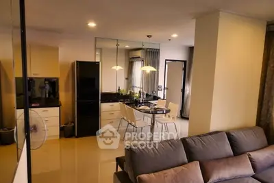 Modern open-plan living room and kitchen with sleek design and cozy ambiance