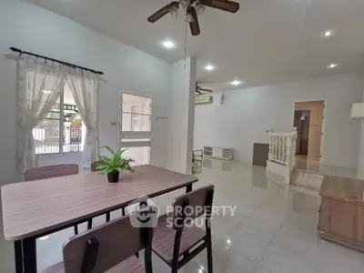 Spacious open-plan living and dining area with modern decor and natural light.