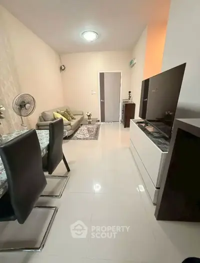 Modern living room with sleek furniture and dining area, perfect for cozy gatherings.