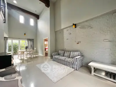 Spacious living room with high ceilings and natural light