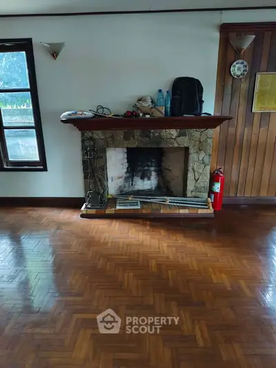 Charming living room with rustic stone fireplace and wooden flooring