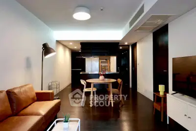 Modern living room with leather sofa and open kitchen layout