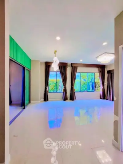 Spacious living room with large windows and elegant lighting fixtures