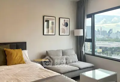 Modern bedroom with city view, cozy sofa, and stylish decor
