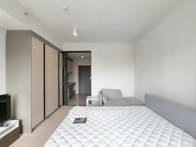 Modern studio apartment with cozy living area and sleek kitchen design