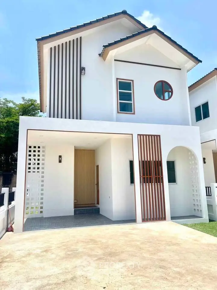 Modern two-story house with unique architectural design and spacious driveway.