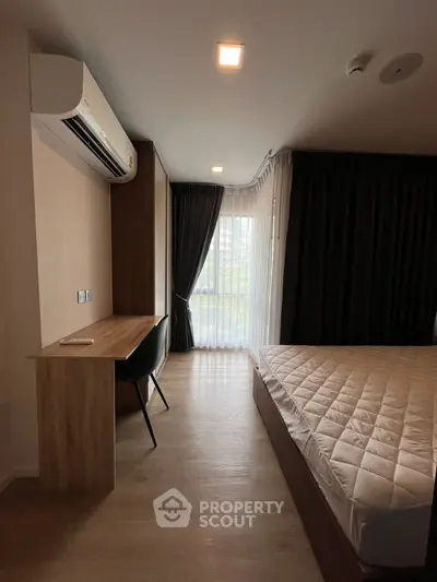Modern bedroom with sleek design, featuring a comfortable bed, stylish desk, and large window with curtains.