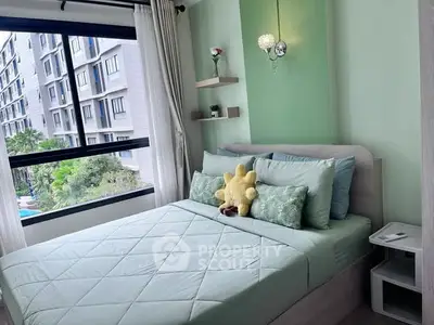 Cozy bedroom with modern decor and large window offering a view of the building exterior.