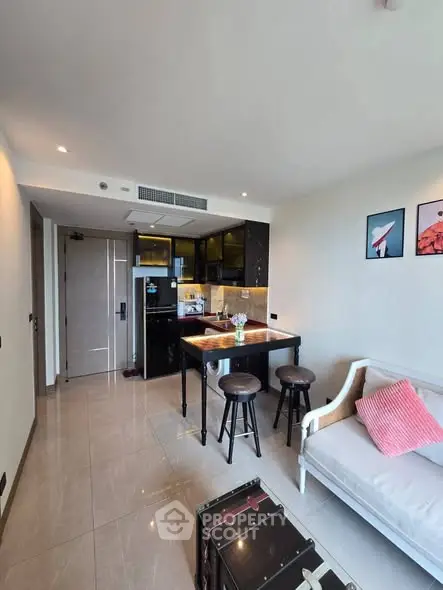 Modern open-concept living room with stylish kitchen and cozy seating area.