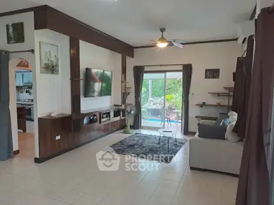 Spacious living room with modern decor and garden view, perfect for relaxation and entertainment.