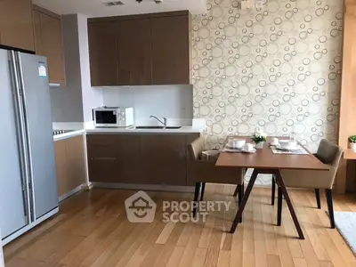 Modern kitchen with sleek cabinets and dining area in stylish apartment